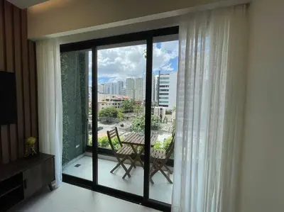 a balcony with a table and a view of a city at Departamento de lujo en Santo Domingo in Santo Domingo