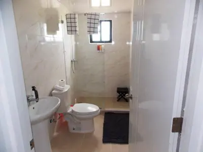 a white bathroom with a toilet and a sink at Cañaveral Del Mar 1 Quiet and extremally relaxing! in San Felipe de Puerto Plata