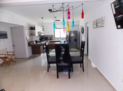a dining room and kitchen with a table and chairs at Cañaveral Del Mar 1 Quiet and extremally relaxing! in San Felipe de Puerto Plata