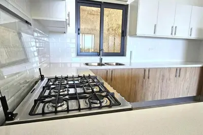 a stove top in a kitchen with a sink at New 2 BR apt with swimming pool at playa bonita in Las Terrenas