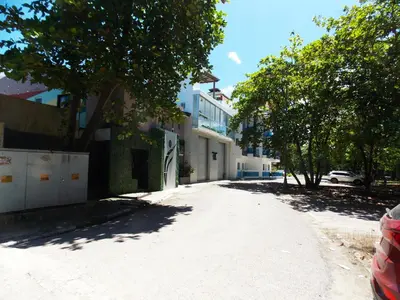 a dirt road with trees and buildings on a street at Residencial Victoria in Sampiño