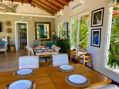 a dining room with a table and chairs at Blue View Beachfront Apartment with Ocean View in Sampiño