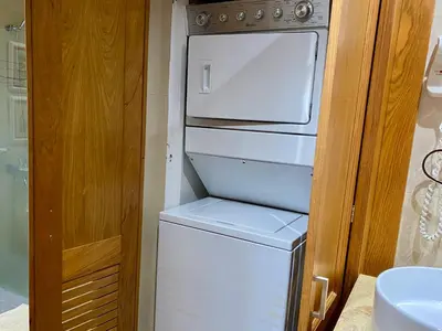 a white washer and dryer in a small kitchen at Blue View Beachfront Apartment with Ocean View in Sampiño