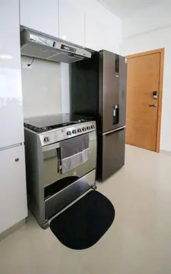 a kitchen with a stove and a refrigerator at Modern City Condo El Millon in El Jobo de Mendoza