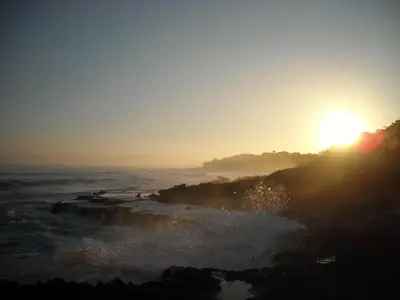 a sunset over the ocean with the sun setting on the horizon at Bluefish Condo, Ocean Front, Sunrises, Pool, Hot Tub, Under New Management in Sosúa