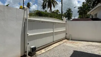 a white fence with a gate in front of a house at Villa 4Bdrms 3.5baths with pool, Jacuzzi and Starlink WiFi in Las Terrenas