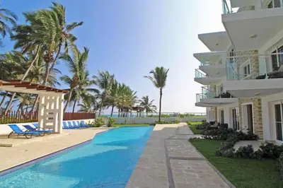 a villa with a swimming pool and palm trees at Direct View and Access to Beach! in Eslabón