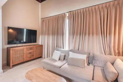a living room with a couch and a flat screen tv at Apartment nearby the beach at Portillo RAA in Las Terrenas