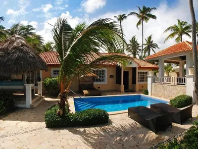 a house with a swimming pool and a palm tree at Paradisus Punta Cana Resort All Inclusive in Punta Cana