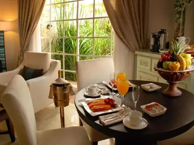 a table with a breakfast of fruit and orange juice at Paradisus Punta Cana Resort All Inclusive in Punta Cana