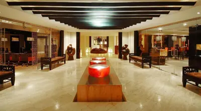a lobby with a red vase on a wooden table at The Reserve at Paradisus Punta Cana - All Inclusive in Punta Cana