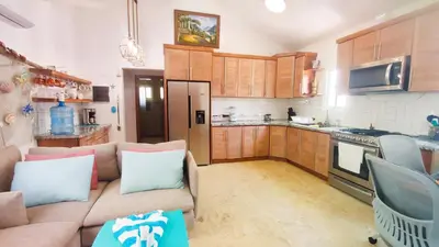 a living room with a couch and a kitchen at Brisa Atlántico - Secluded Beach in La Piña