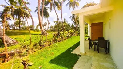 a table and chairs on the porch of a house at Brisa Atlántico - Secluded Beach in La Piña