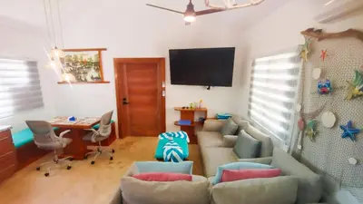 a living room with a couch and a tv at Brisa Atlántico - Secluded Beach in La Piña
