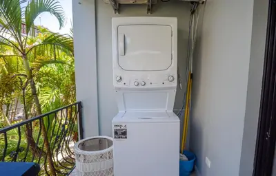 a washer and dryer in a room with a balcony at Beautifully updated in the heart of town in Cabarete