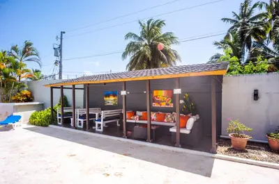 a small shed with a table and chairs at Beautifully updated in the heart of town in Cabarete