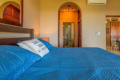 a bedroom with a blue bed with a pillow on it at Truly Beachfront at Quiet Beach in Cabarete