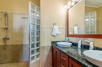a bathroom with a sink and a shower at Truly Beachfront at Quiet Beach in Cabarete