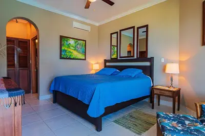 a bedroom with a blue bed in a room at Truly Beachfront at Quiet Beach in Cabarete