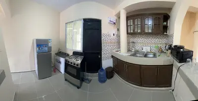 a small kitchen with a stove and a sink at Tu casa los frailes 2da in La Alianza