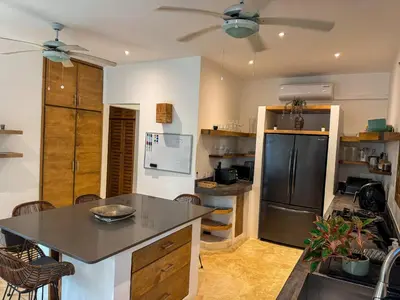 a kitchen with a refrigerator and a table and chairs at Villa Vista in Las Terrenas