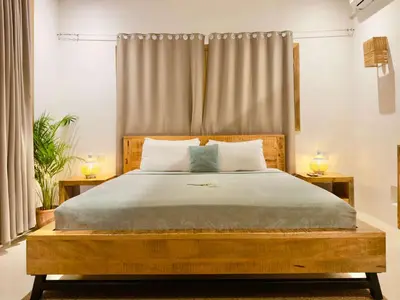 a bedroom with a large bed with two night stands at Villa Vista in Las Terrenas