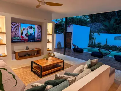 a living room with a couch and a tv at Villa Vista in Las Terrenas