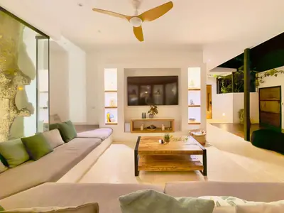 a living room with a couch and a ceiling fan at Villa Vista in Las Terrenas