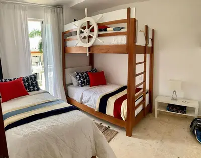 a bedroom with two bunk beds and a window at Luxury Penthouse Coson bay in Las Terrenas