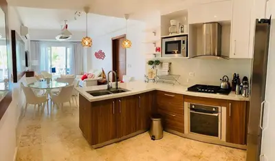 a kitchen with a sink and a table in it at Luxury Penthouse Coson bay in Las Terrenas