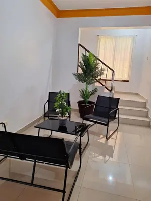 a living room with two chairs and a table with plants at Casa Rural con Piscina in Azua de Compostela