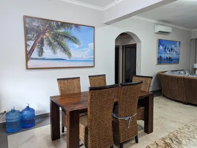 a dining room with a wooden table and chairs at Ocean One Beach Condos Cabarete in Cabarete