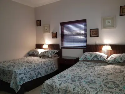 a bedroom with two beds and a window at Ocean One Beach Condos Cabarete in Cabarete