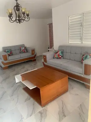 a living room with two couches and a coffee table at Romeos Place in Las Coles