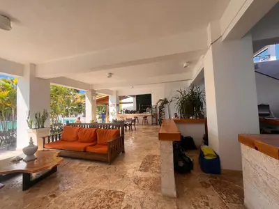 a living room with an orange couch and a table at Residencial Paraiso C102 in Bayahibe