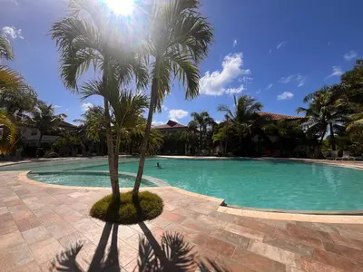 a palm tree in the middle of a swimming pool at Residencial Paraiso C102 in Bayahibe