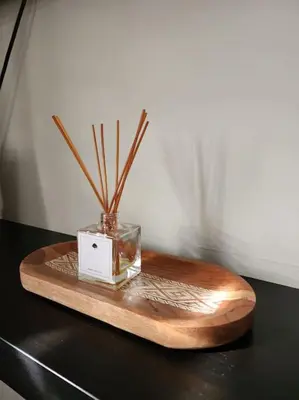 a vase on a wooden board with sticks in it at Rooftop Apartment in Villa Francisca