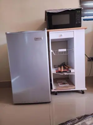 a refrigerator with a microwave on top of it at Rooftop Apartment in Villa Francisca