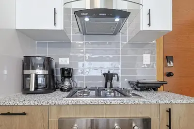 a kitchen with a sink and a stove at Cozy, Centric 1BR Condo, Pool in Los Prados