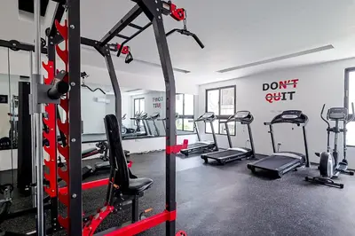a gym with several tread machines in a room at Cozy, Centric 1BR Condo, Pool in Los Prados