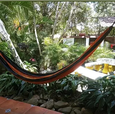 a hammock in the middle of a garden at Villabenedetta santo domingo in Varía