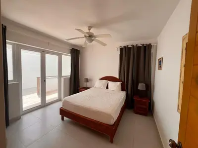 a bedroom with a bed and a ceiling fan at Residencial Paraíso A101 in Bayahibe