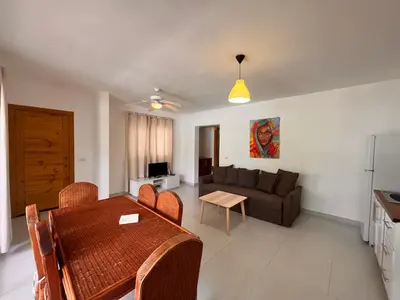 a living room with a table and a couch at Residencial Paraíso A101 in Bayahibe