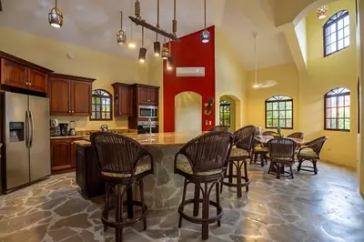 a large kitchen with a table and chairs at Cabarete Oceanview Villa Pool Oasis Beach Access in Cafemba