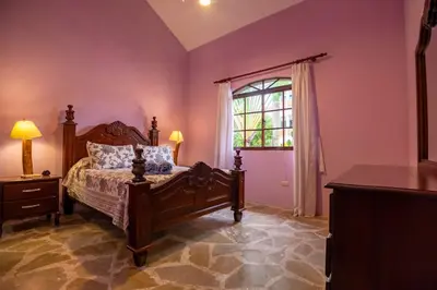a bedroom with a bed and a window at Cabarete Oceanview Villa Pool Oasis Beach Access in Cafemba