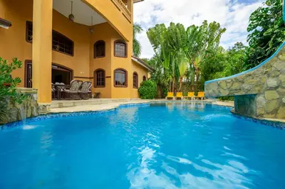 a swimming pool with a slide in front of a house at Cabarete Oceanview Villa Pool Oasis Beach Access in Cafemba