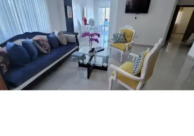 a living room with a blue couch and chairs at Charming 2BR Apt Near Beach in Sabana Grande