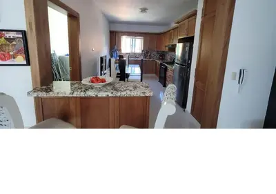 a kitchen with a bowl of fruit on a counter at Charming 2BR Apt Near Beach in Sabana Grande