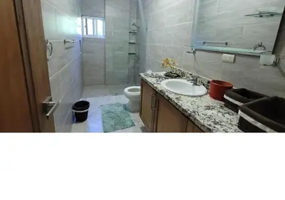 a bathroom with a sink and a shower and a toilet at Charming 2BR Apt Near Beach in Sabana Grande