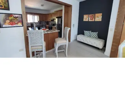 a kitchen with a table and chairs in a room at Charming 2BR Apt Near Beach in Sabana Grande